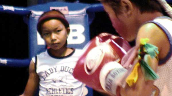 Three Rounds of Boxing 4 Photo courtesy of 108 Media Stam performs the Wai Kru before a fight as Pet looks on.