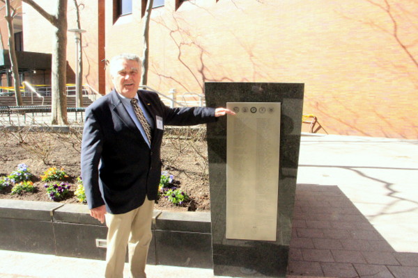 Vince McGowan, a Vietnam War veteran who is organizing the effort to restore the veterans' memorial at 55 Water St., shows how high the water got from Hurricane Sandy. Downtown Express photo by Kaitlyn Meade 