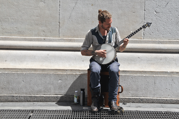 Photo by Tequila Minsky With a banjo on his knee, a cymbal under one foot and a bass drum pedal athumped a beat on his suitcase seat, this guy was a one-man band.