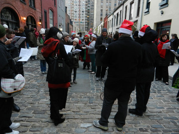 Just Do Art 2 Have songbook, will travel: Carolers make a stop at Washington Mews, during 2012’s Greenwich Village Caroling Walk. PHOTO BY DAVIS FOULGER