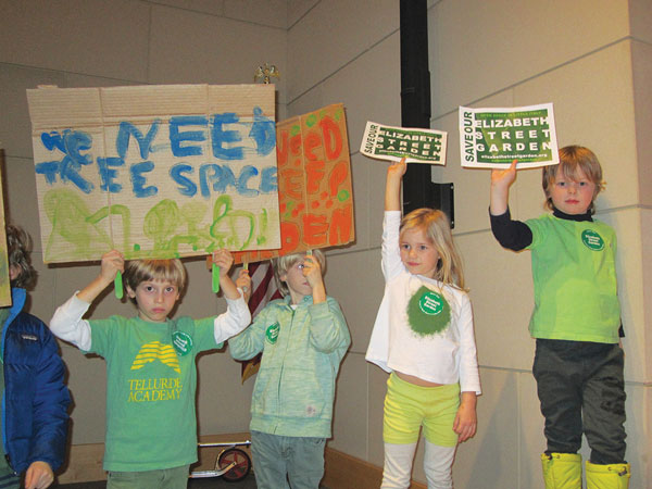 Must try suing to save garden 2 Young Elizabeth St. Garden activists made their point clear at the November 2013 C.B. 2 meeting, hoisting their signs up in the front of the auditorium, right next to where the community board officers were seated on stage. C.B. voted overwhelmingly to preserve the garden in perpetuity. Photo by The Villager