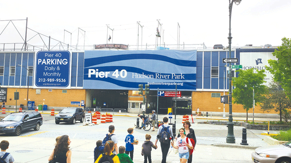 ‘Up in the air’: How big will rebuilt Pier 40 be? 3 A typical scene at Pier 40 in Hudson River Park includes droves of young athletes and parents streaming to and from the pier’s artificial-turf sports fields. The trapeze has relocated to Williamsburg. The Hudson River Park Trust and local youth sports leagues will be looking at removing the pier shed on the east (above) and west sides of the pier, and re-massing the pier's commercial space on its northern and southern edges. If that was done, this view above might be of the Hudson River in the background of the playing fields. File photo by The Villager