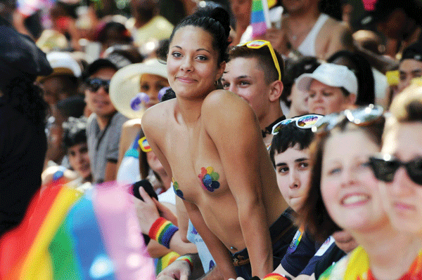 Laverne, love and lots of angels at Pride March 9 Photos by Milo Hess (Cox; vertical angel wings; “Love and Let Love”; “Born This Way”; mask and whistle); Q. Sakamaki (scaffolding cheerers; soaring angel wings); Jonathan Alpeyrie (woman amid crowd)