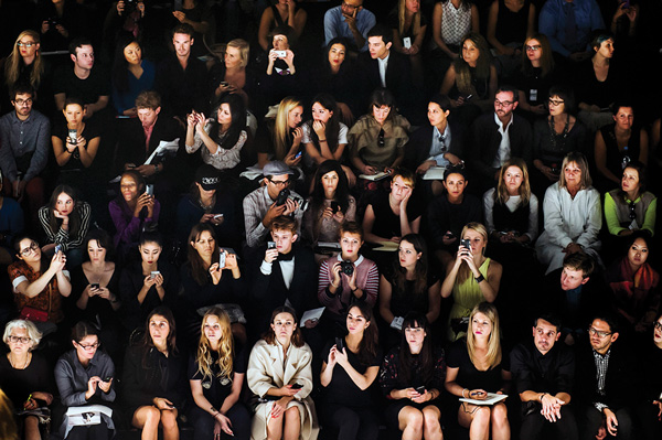 A crowd watches the Issey Miyake runway show at Paris Fashion Week, Spring 2014.  Courtesy of Anastasia Photo ©Dina Litovsky