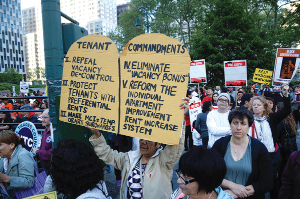 All marching to one tune: Rent freeze! 1 A marcher with the “Holy Grail” of reforms that tenants seek. Photos by Jefferson Siegel
