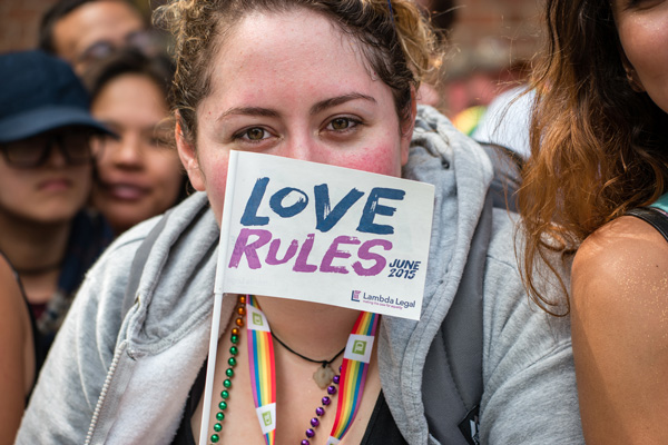 Supremely Proud crowd revels in marriage ruling at Stonewall 2 At the Pride March, a supporter of Lamba Legal said it’s time to “let love rule.” Lambda Legal represented four couples who were plaintiffs in the U.S. Supreme Court gay-marriage lawsuit. Photo by Milo Hess