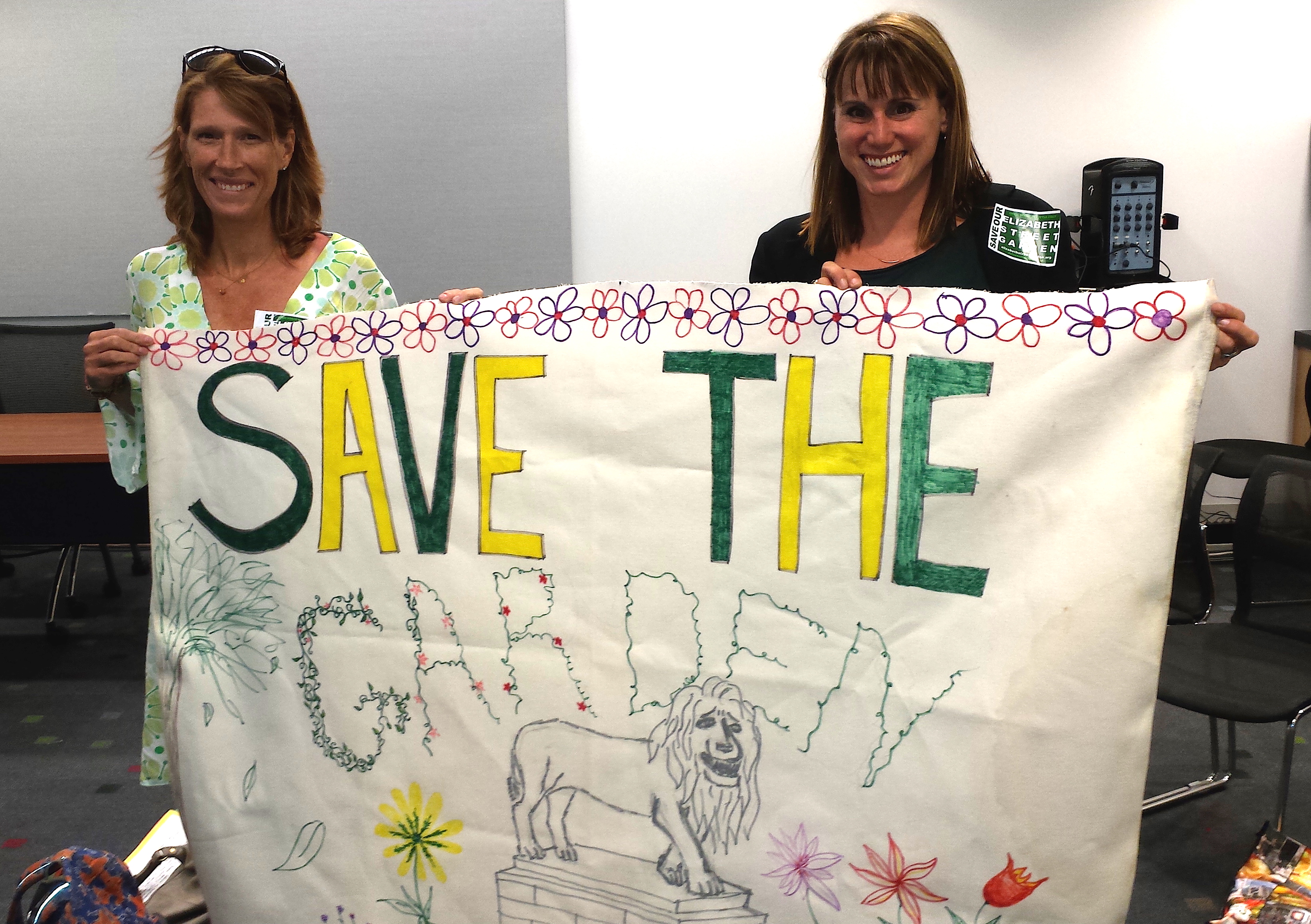 No more shell games 2 Elizabeth St. Garden leaders Emily Hellstrom, left, and Jeannine Kiely proudly displayed a banner for the garden at a hearing last year for funding from the Lower Manhattan Development Corporation for an affordable housing project proposed for the garden. L.M.D.C. denied the funds, but the city and City Councilmember Margaret Chin are still pushing on with the face in the face of united community and political opposition.