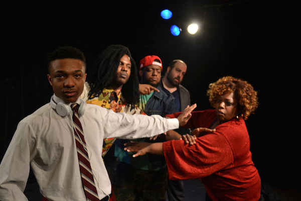 The current version of 13th Street Rep’s long-running “Line” acknowledges 21st century realities, such as smartphones and earbuds. Courtesy Women of Color Productions. 