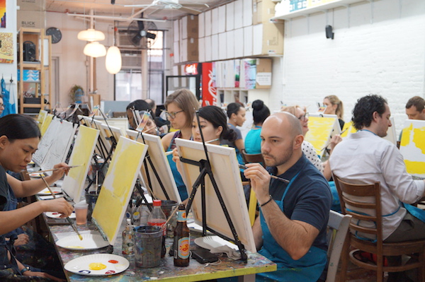 Where booze and brushwork mix 5 Attendees to Painting Lounge's class work on their skyline painting. Photo by Nicole Javorsky.