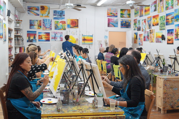 Where booze and brushwork mix 3 At the Painting Lounge, people keep their eyes on their paintbrushes as they listen to instructor Charles Sommer. Photo by Nicole Javorsky.