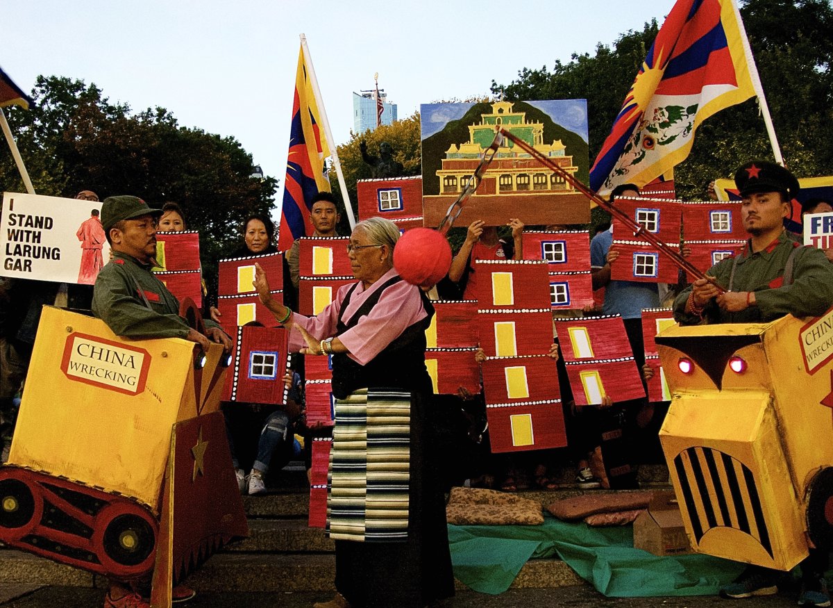 Union Square rally against evictions...in Tibet 2 During the protest for Larung Gar last month in Union Square, activists portraying Chinese demolition machines symbolically threatened to destroy the Buddhist enclave as a senior woman pleaded with them to stop. Photo by Jane Stein