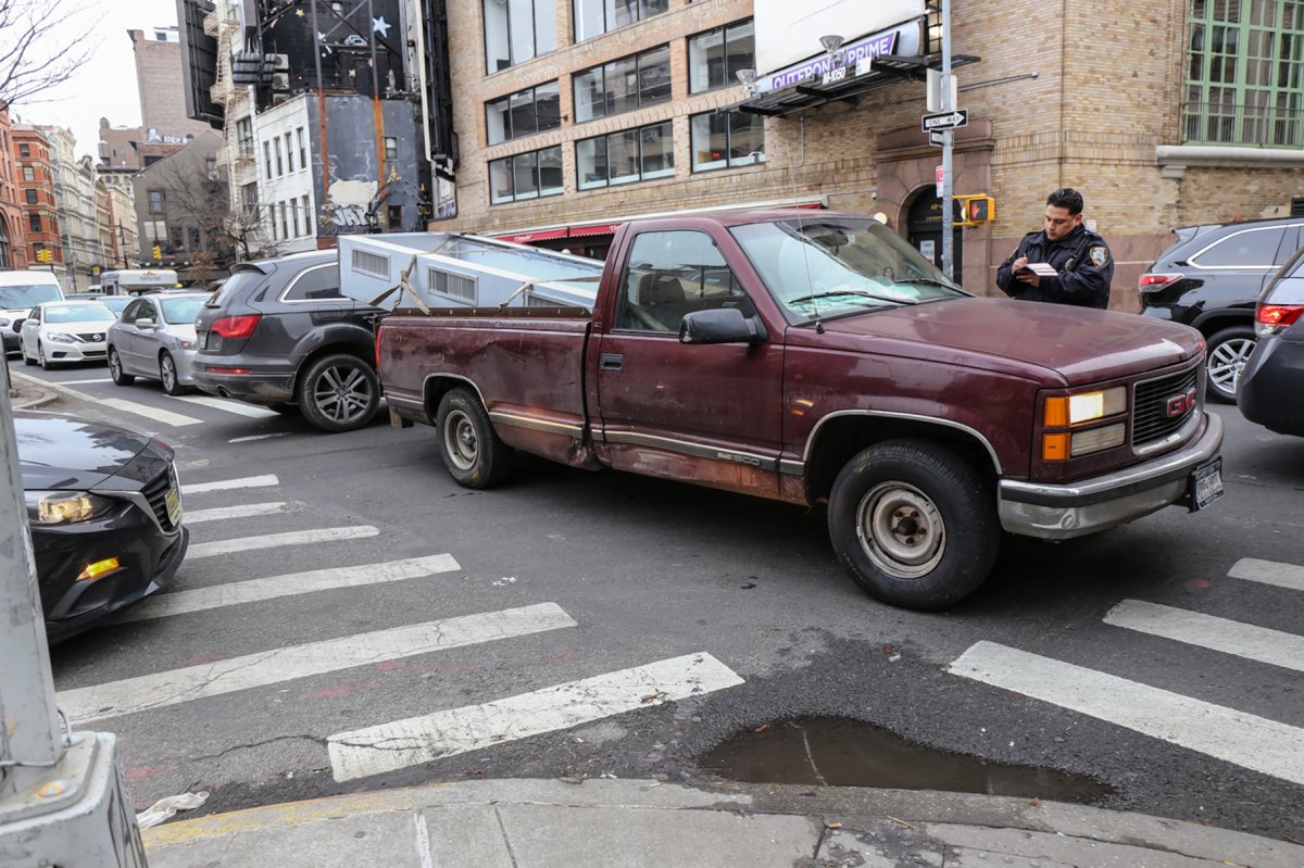 On Tuesday afternoon, a police officer gave a driver a ticket for “blocking the box” at the congested intersection of Watts and Thompson Sts. in Soho on one of the main Holland Tunnel approach routes. The Angry Buddhist and many other Downtowners say the one-way Verrazano toll exacerbates the area's traffic problem. Photo by Tequila Minsky