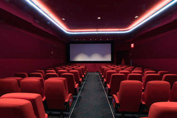 An interior view of the Quad’s “red theater” space, illuminated by a giant neon “U” on the ceiling. Photo by Caleb Caldwell.