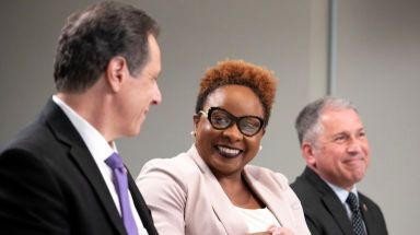 Mecca Nelson, center, shakes hands with Gov. Andrew Cuomo who recently expanded eligibility for a military scholarship.