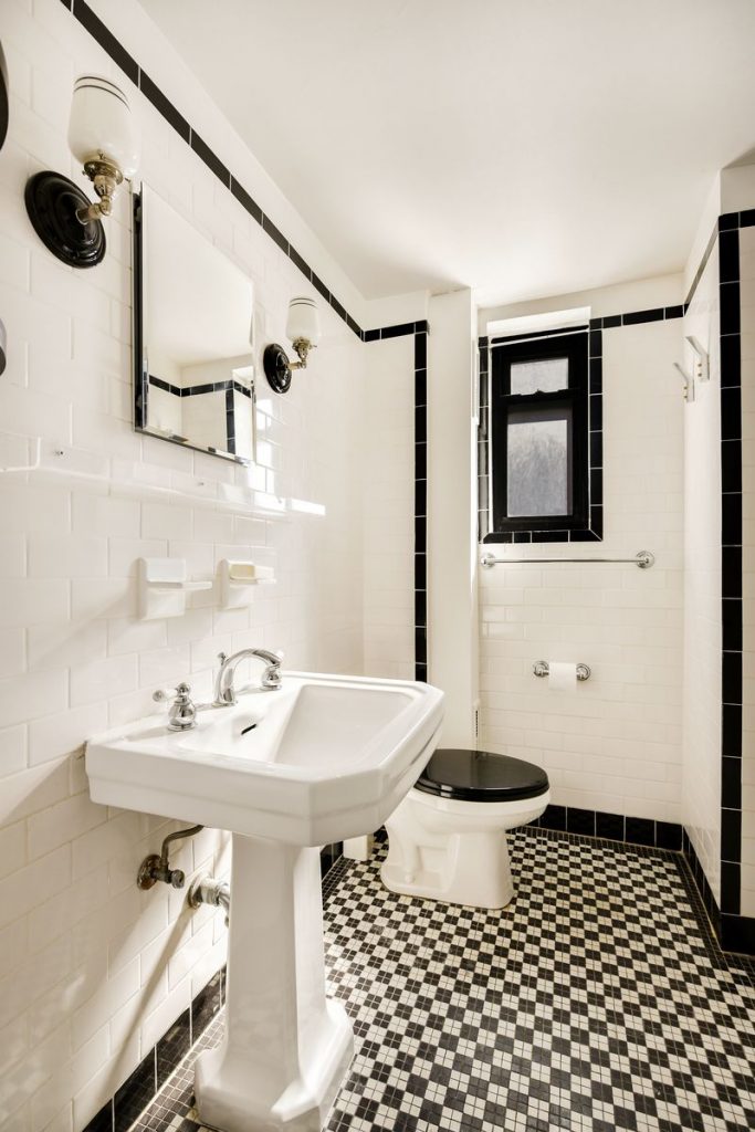 classic black-and-white tiled bathroom comes with this studio at 405 W. 23rd St