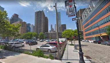 The parking lot at 250 Water St., with the Peck Slip School across the street to the right (Google Maps)