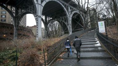 A man and woman walk up the stairs to St. Clair Place in Riverside Park. (Jan. 6, 2014)