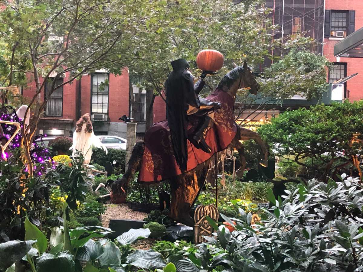 A headless horseman rides through the cemetery.