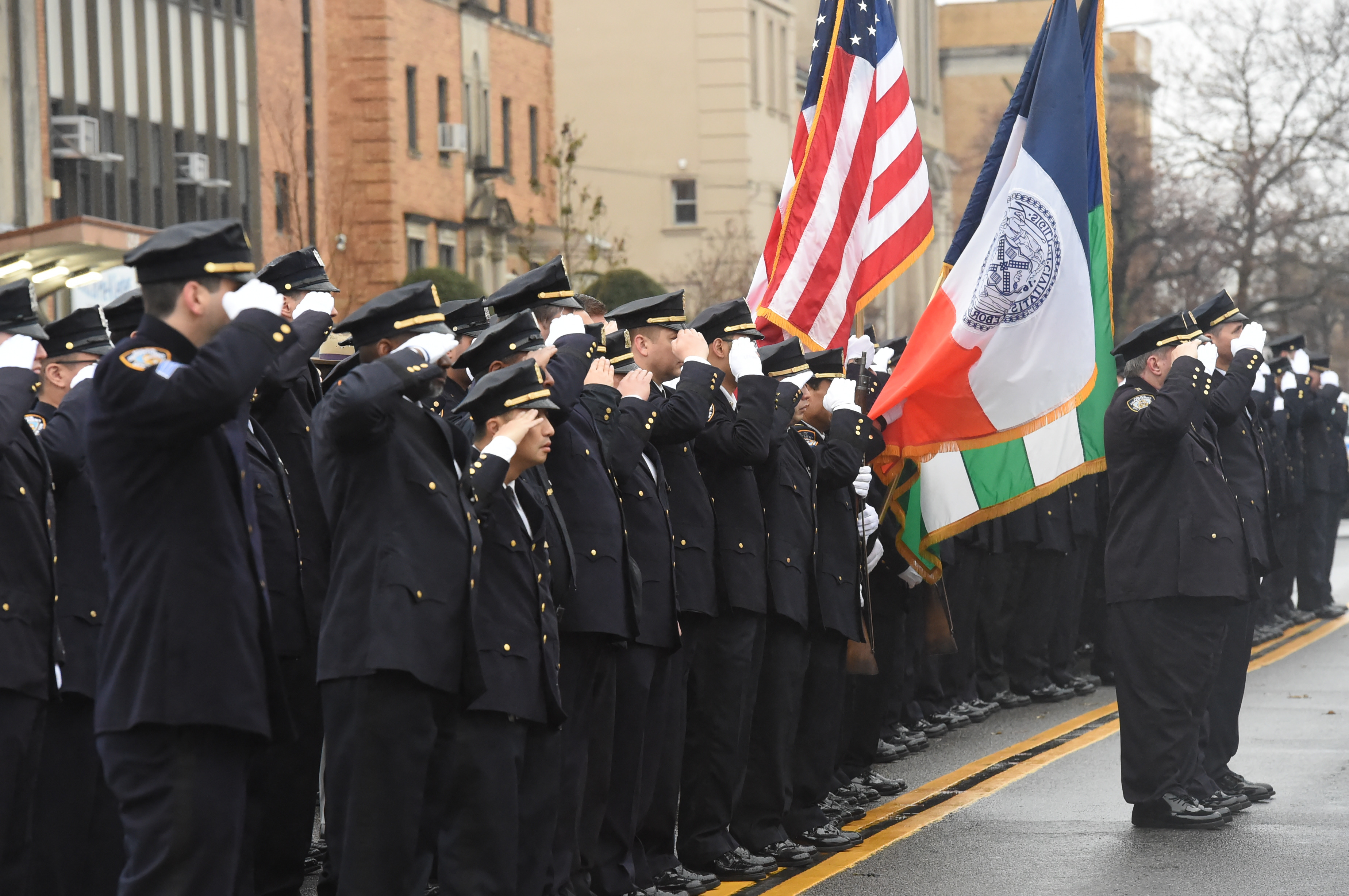 A line of police officers honor the memory of Police Officer Garman Chen