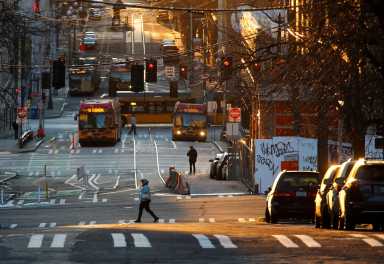 A person crosses the street in the International District-Chinatown neighborhood during the outbreak of coronavirus disease (COVID-19), in Seattle