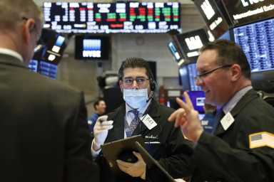 Traders work on the floor of the NYSE in New York
