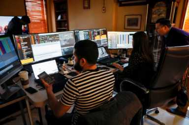 NYSE-AMEX Options floor traders from TradeMas Inc. work in an off-site trading office  due to the outbreak of the coronavirus disease (COVID-19), in New York
