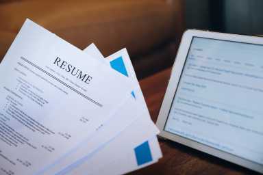 woman holding resume application with using tablet digital to job search on internet. applying for a job concept.