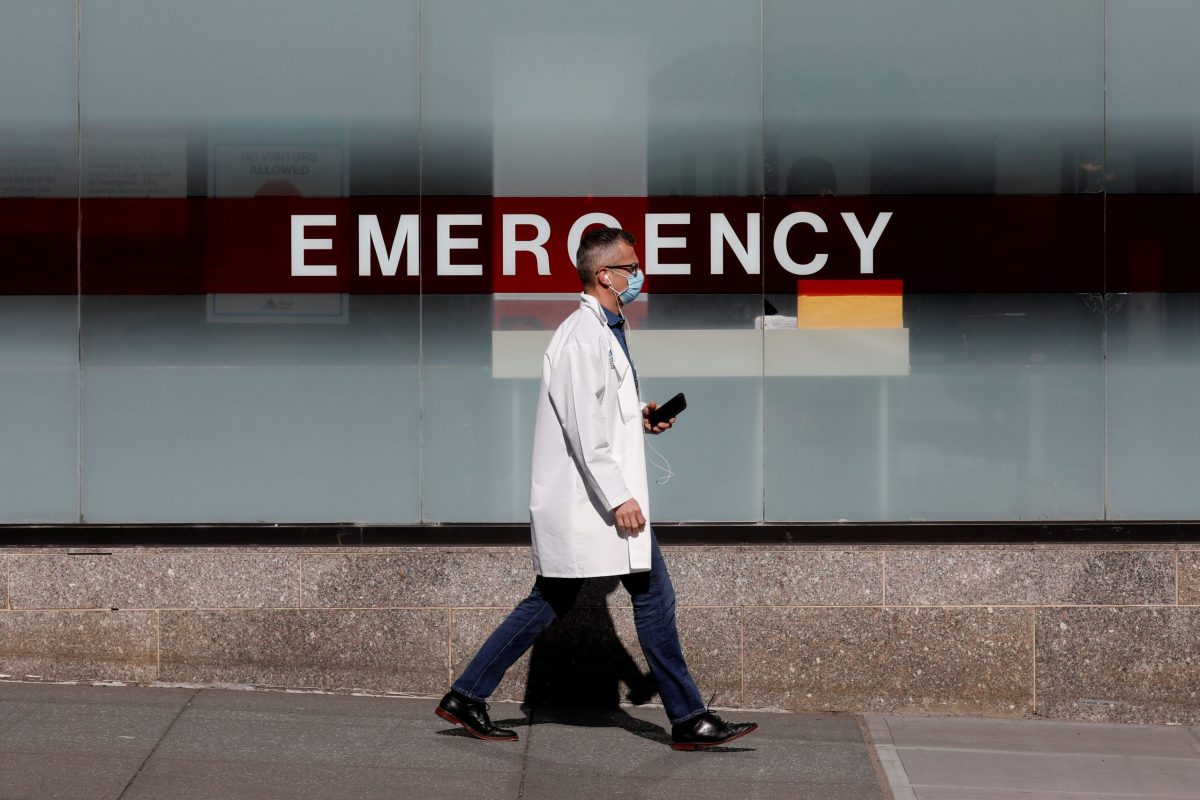 A doctor wears a protective mask as he walks outside Mount Sinai Hospital during the outbreak of coronavirus disease (COVID-19) in New York