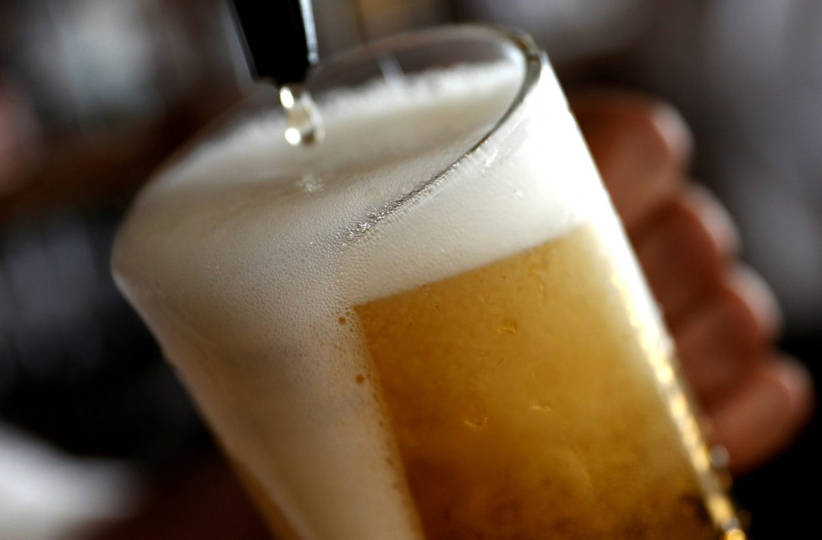 FILE PHOTO: A pint of beer is poured into a glass in a bar in London