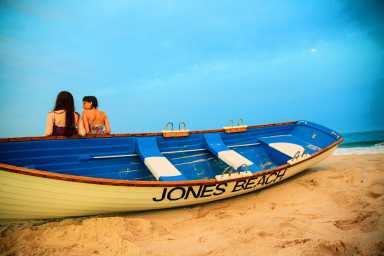 Two girls stay at the Jones Beach at the sunset