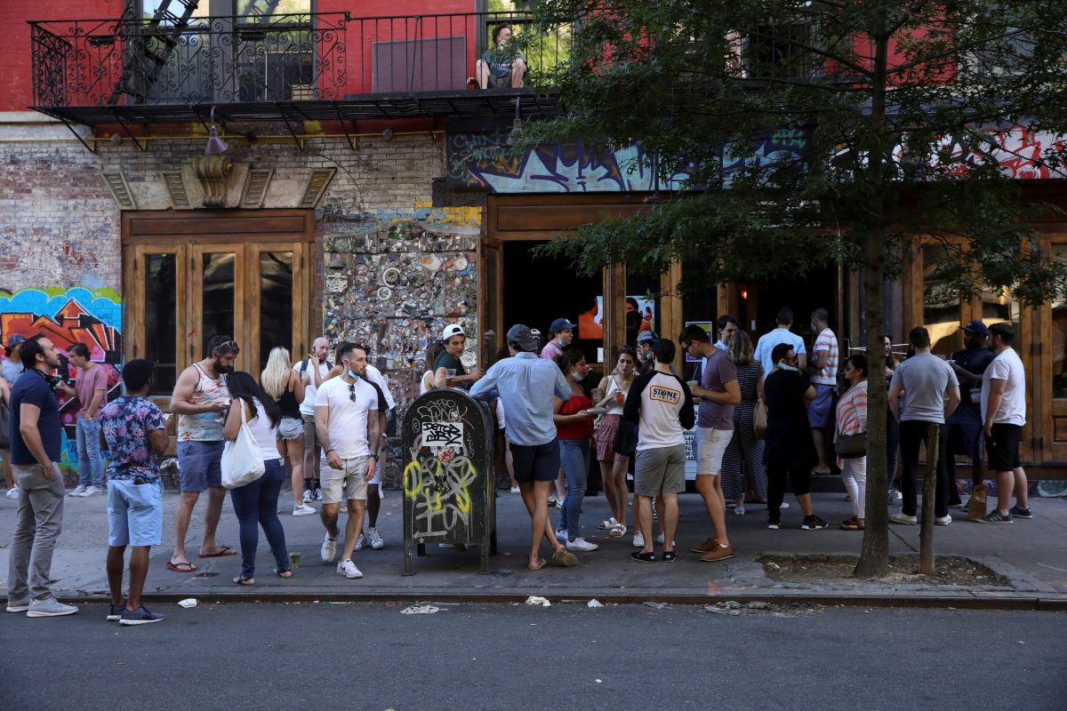 People drink outside a bar during the reopening phase following the coronavirus disease (COVID-19) outbreak