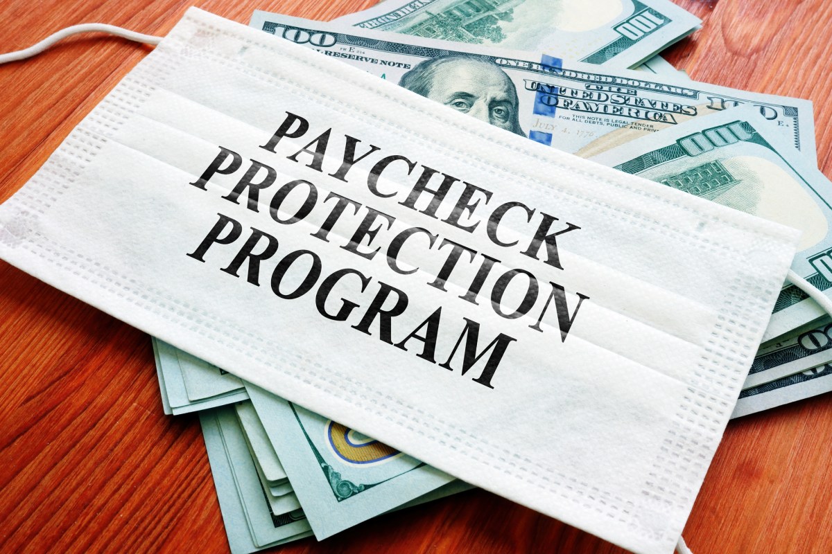 PPP Paycheck Protection Program as SBA loan written on the mask and money.