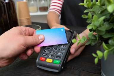 Customer making wireless or contactless payment using credit card