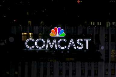 The NBC and Comcast logo are displayed on top of 30 Rockefeller Plaza, formerly known as the GE building, in midtown Manhattan in New York