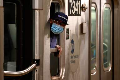 A New York City Transit conductor in Manhattan on first day of phase one reopening in New York City