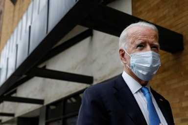 U.S. Democratic presidential candidate and former Vice President Joe Biden stops to answer questions as he exits The Queen theater in Wilmington