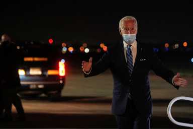 U.S. Democratic presidential candidate Joe Biden greets members of his staff and the press as he exits his campaign plane after campaigning in Miami
