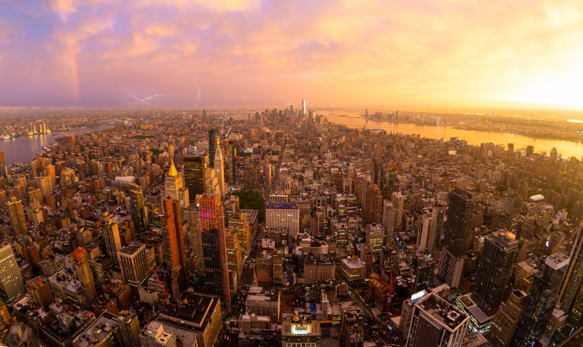 New York City skyline with Manhattan skyscrapers at dramatic stormy sunset, USA.