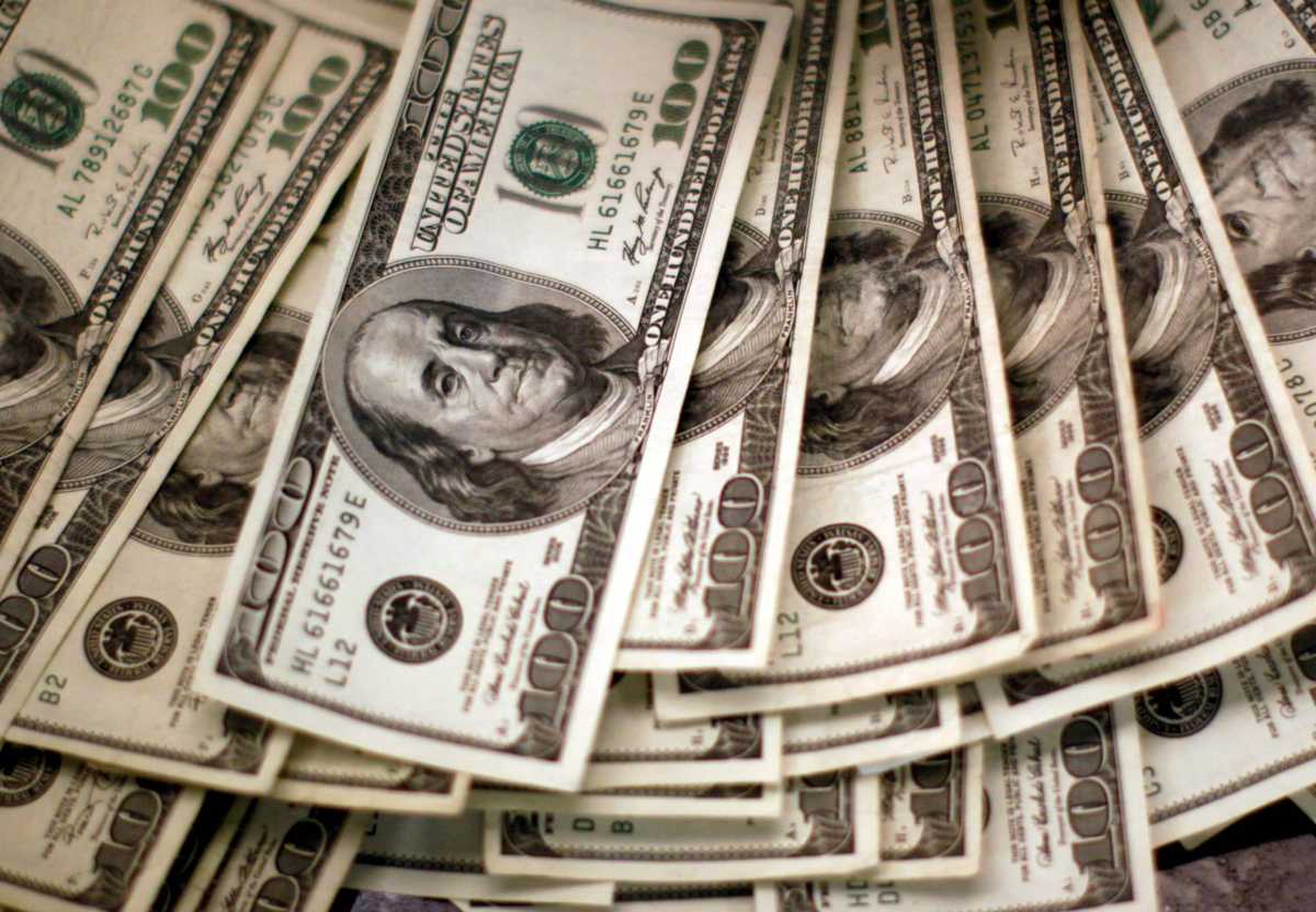 U.S. dollars are counted out by a banker at a bank in Westminster