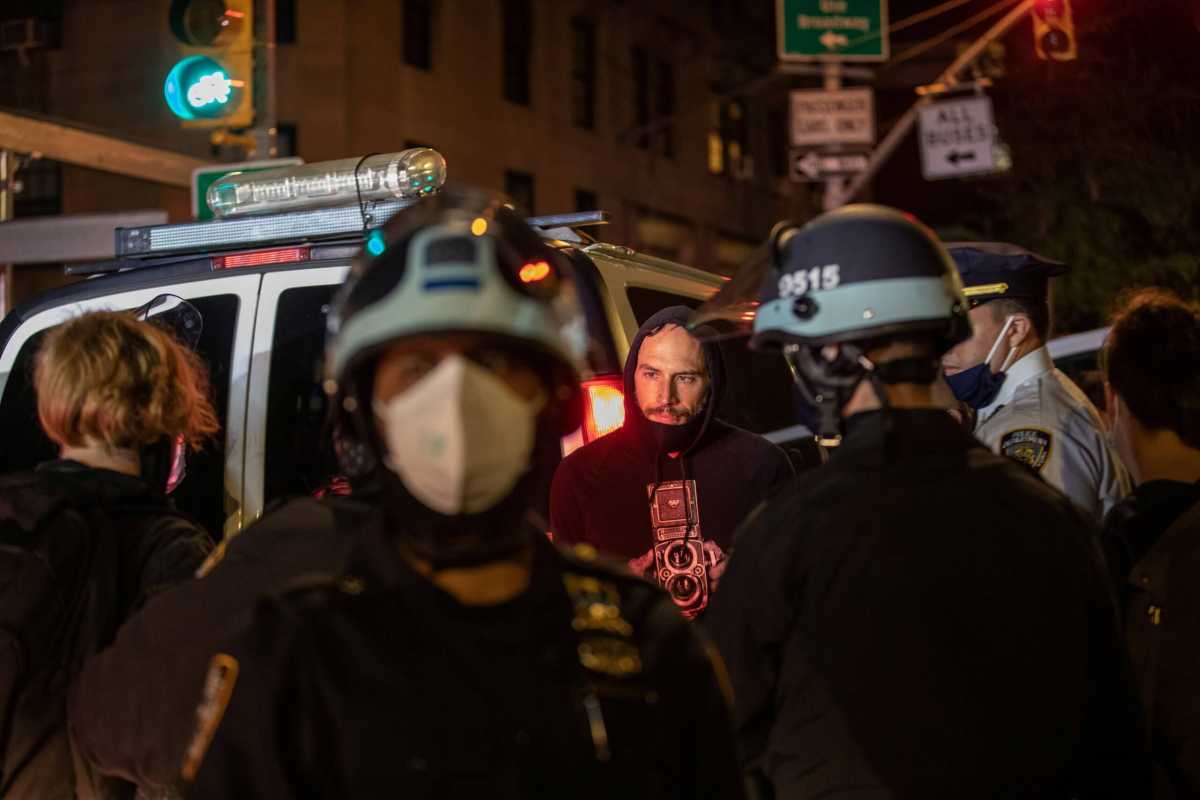 Police officers stand next to detained demonstrators near Washington Square park the day after Election Day in Manhattan, New York City