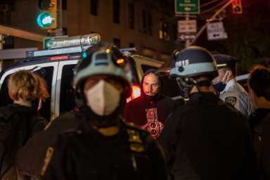 Police officers stand next to detained demonstrators near Washington Square park the day after Election Day in Manhattan, New York City