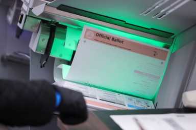 A person counts postal ballots following the 2020 U.S. presidential election, in Downey, near Los Angeles