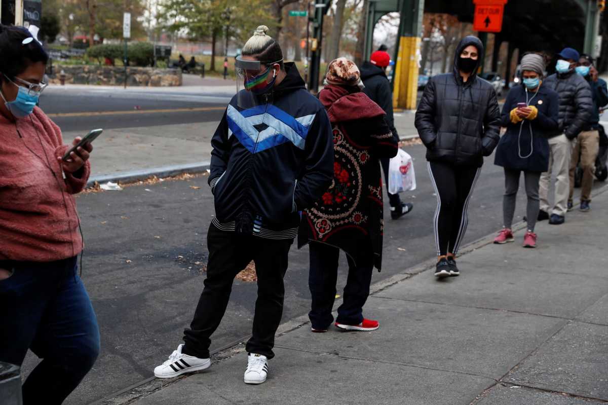 People wearing protective face masks wait in line outside a CityMD Urgent Care, as the global outbreak of the coronavirus disease (COVID-19) continues, in the Bronx borough of New York
