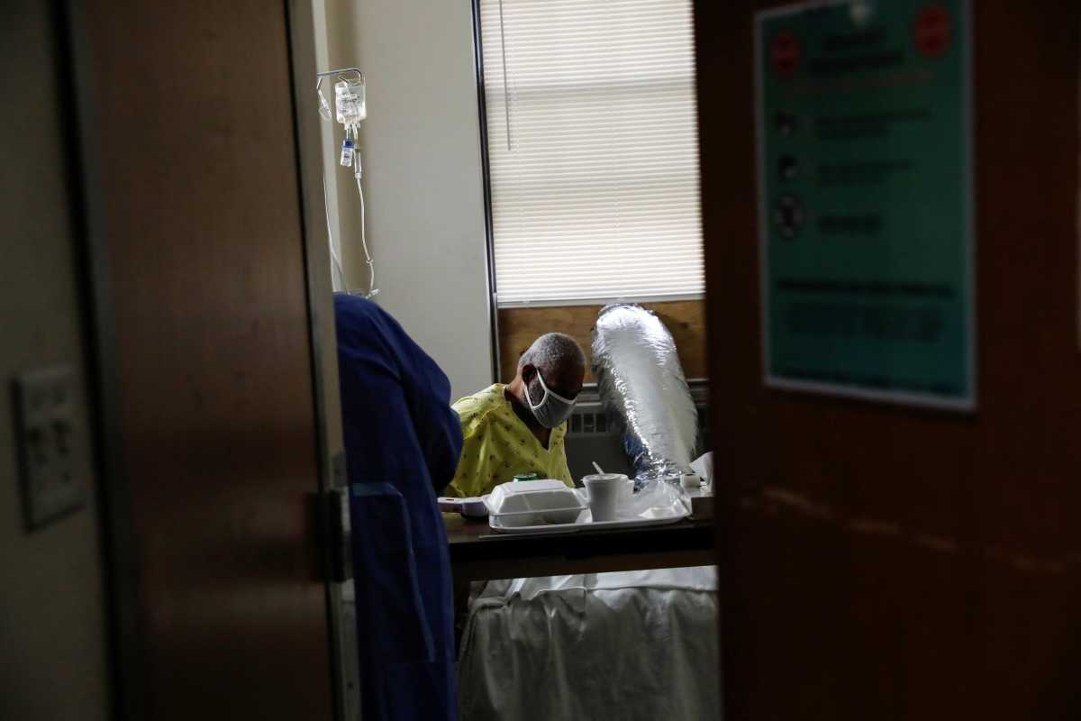 Andre Johnson, a coronavirus disease (COVID-19) positive patient, sits in his isolation room at Roseland Community Hospital on the South Side of Chicago, Illinois