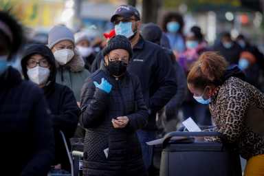 FILE PHOTO: People line up to receive free holiday boxes of food in New York