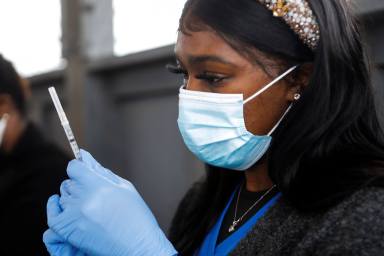 People line up at a coronavirus disease (COVID-19) vaccination site in Plant City, Florida