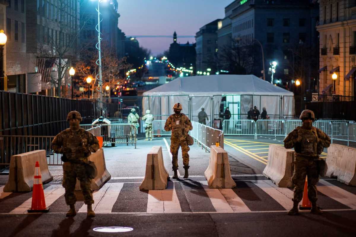 National Guard members get instructions as others stand guard near the White House ahead of U.S. President-elect Joe Biden’s inauguration, in Washington