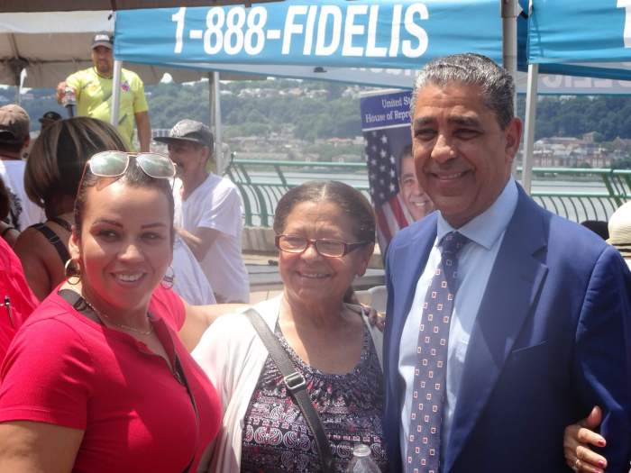 Rep. Adriano Espaillat standing with some of his constituents. Photo by William Engel