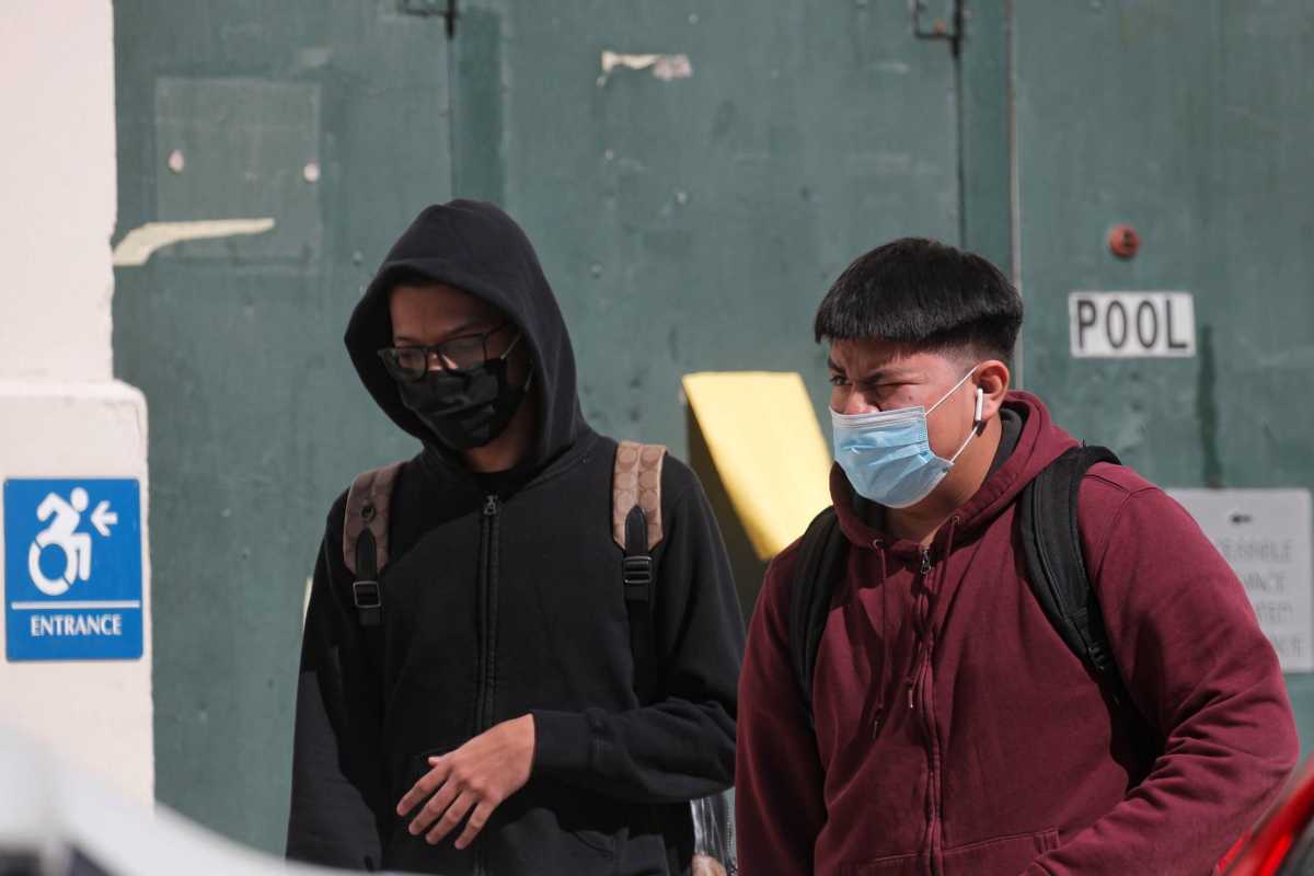 Students exit following the return to in-person learning for New York City High School students, as the global outbreak of the coronavirus disease (COVID-19) continues, at John Jay High School in Brooklyn, New York