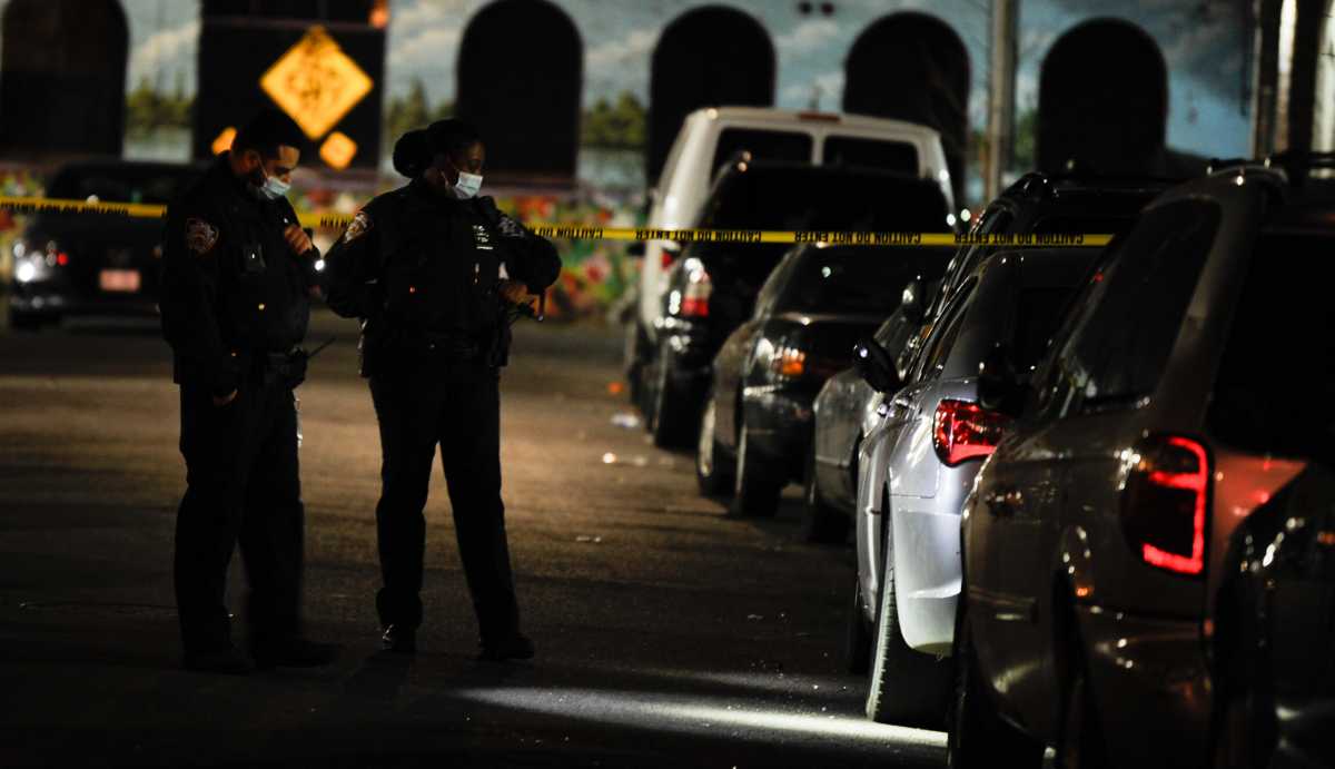 Cops from the 71 Precinct probe a shooting at 2122 Beekman Place.